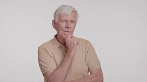 Gray haired man in a thoughtful pose, hand at chin studio shot Stock Footage 263931333