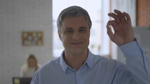 Gray-haired solid man shows gesture okay. top manager in the office 4K Stock Footage 112877463