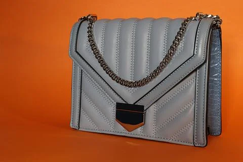 Gray handbag with a silver chain. Stock Photos