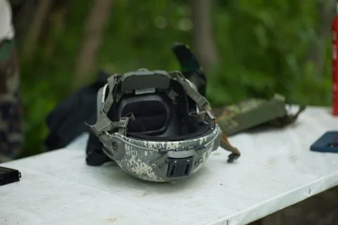 Gray helmet lies on the table Stock Photos