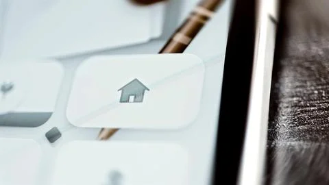 Gray home icon on white interface button Fotos Stock