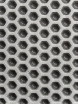 A gray honeycomb-patterned EVA mat for cars or home use that features a per.. Stock Photos