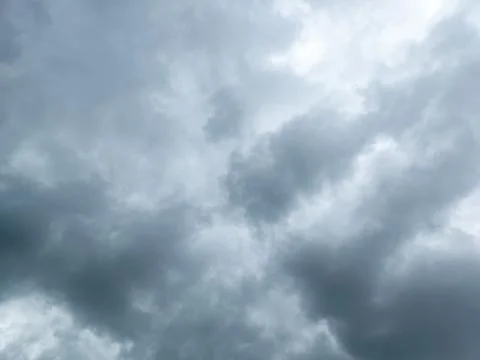 Gray incoming storm clouds background, upward view Stock Photos