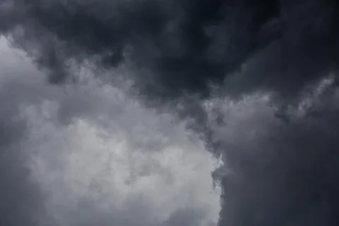 Gray incoming storm clouds dark closeup backdrop Stock Photos
