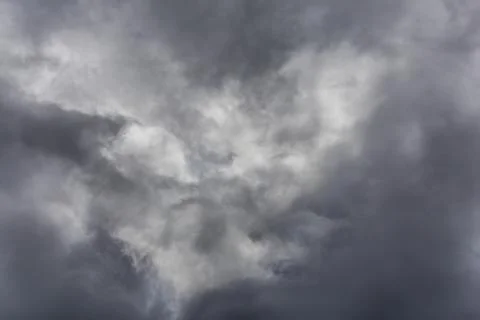 Gray incoming storm clouds dark closeup backdrop Stock Photos