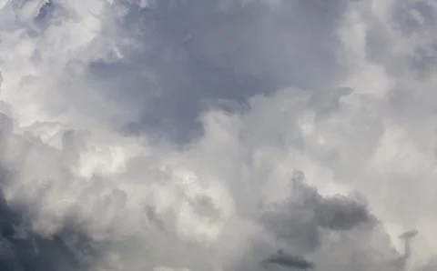 Gray incoming storm clouds dark closeup backdrop Stock Photos