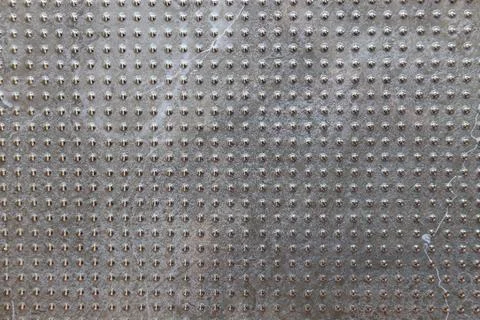 Gray industrial tile texture with repeating geometric grid pattern Foto stock