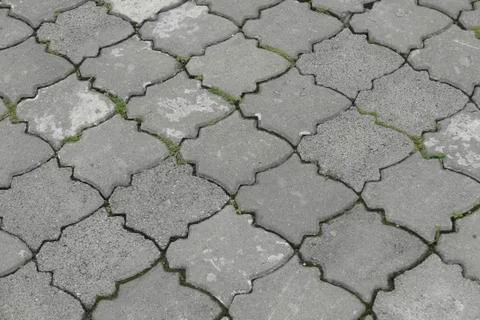 Gray interlocking paving stone driveway directly from above. Stock Photos