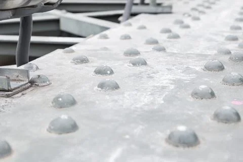 Gray iron surface with rivets horizontal part of the bridge Stock Photos