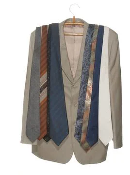 Gray jacket with assorted ties on a wooden hanger with a metal hook isolated Foto stock