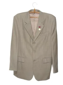 Gray jacket with a medal on a wooden hanger with a metal hook isolated on a w Stock Photos