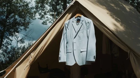 Gray Jacket On Wooden Clothes Rack. Jacket Hangs On A Tent In The Woods. Stock Footage 108741132