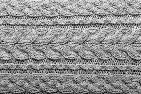 Gray knit pattern with Irish cables Stockfoto's