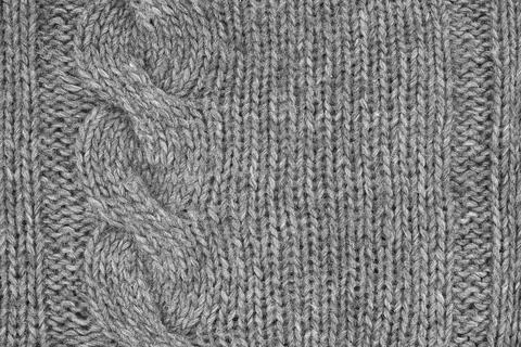 Gray knitted texture with a relief pattern. Handmade Knitwear. Background Stock-Fotos