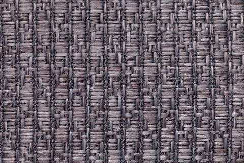 Gray knitted woolen background with a pattern. Texture of textile closeup. Stock Photos