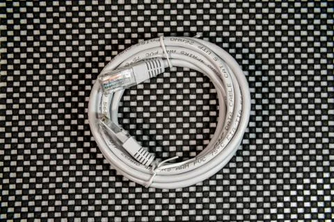 Gray lan cable and connector on black and white background Stock Photos