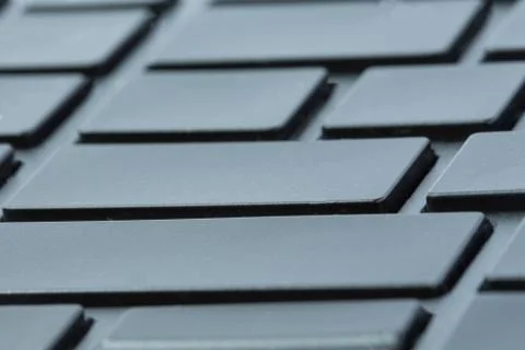 Gray laptop keyboard close-up without inscriptions. Selective focus on enter Stock Photos