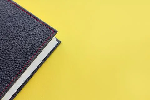 Gray leather diary on a yellow background. the concept of planning. Color of 写真素材