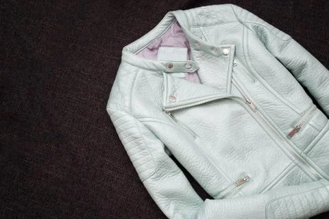 Gray leather jacket. Black background. Fashionable concept, top view Stock-Fotos