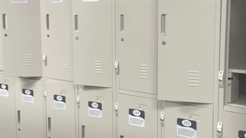 Gray lockers with numbers for people's clothes in the gym locker room. Close-up Stock Footage 303640831