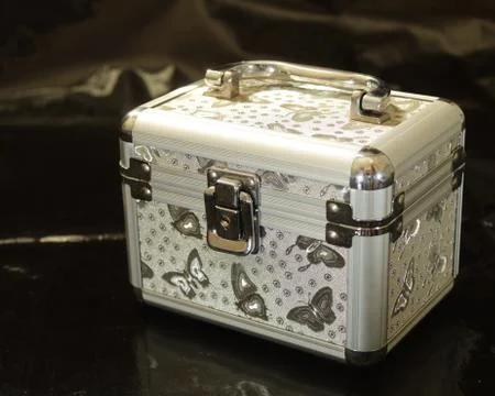 Gray makeup case on a black background Stock Photos