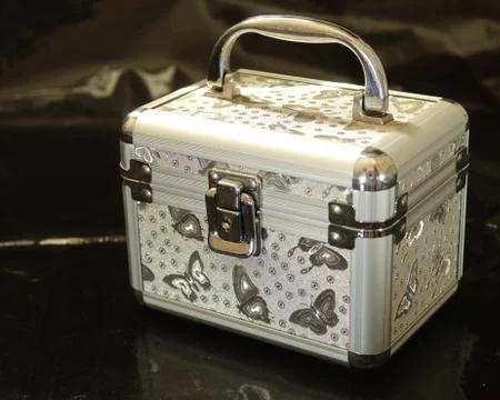 Gray makeup case on a black background Stock Photos