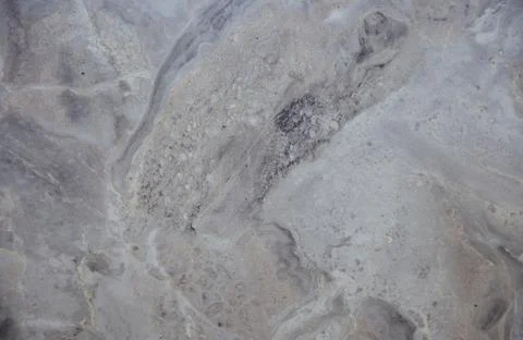 Gray marble, flat polished surface of natural stone with a wavy pattern close Stock Photos