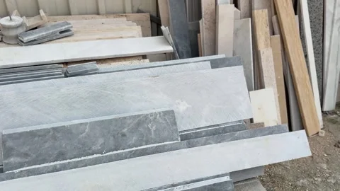 Gray marble slabs stacked outdoors, showcasing texture and pattern for cons.. Stock Footage 330897489