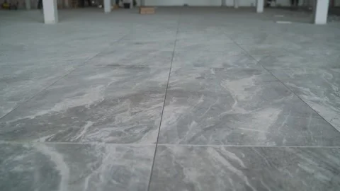 Gray marble tile flooring installation in a modern building Stock Footage 307685386