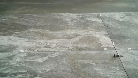 Gray marble tile flooring installation in a modern building 스톡 사진