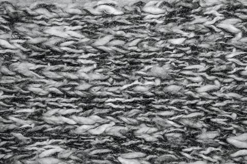 Gray melange fluffy woven thread sweater or scarf as a background. Stock Photos