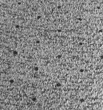 Gray melange knitted fabric texture with dark polka dot pattern Stock Photos