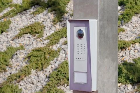 Gray metal button on post for exiting the fenced area against the background  Stock Photos