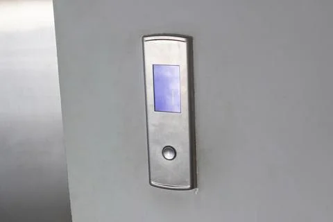 Gray metal elevator button on the wall Foto stock