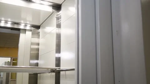Gray metal elevator with a mirror in front of the door Stock Footage 216897193