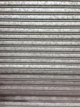 Gray metal shutter with horizontal ridges Stock-Fotos