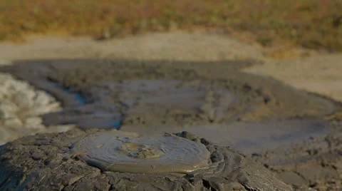 Gray Mud Slowly Erupting Out Of Active Volcano 库存影片 57759468