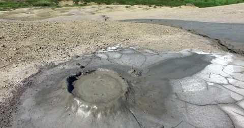 Gray Mud Slowly Erupting Out Of Active Volcano Stock Footage 64984697