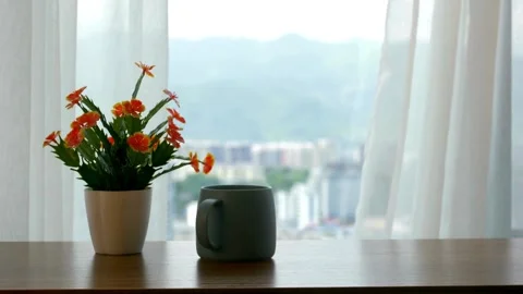 Gray mug and orange flowers on a wooden table Stock Footage 332276786