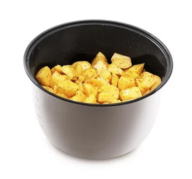 A gray multi-cooker or instant pot insert filled with raw, diced, seasoned .. Stock Photos