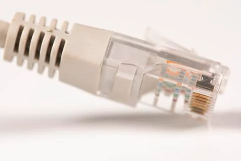 Gray Network Cable with molded RJ45 plug isolated against white background. Stock Photos