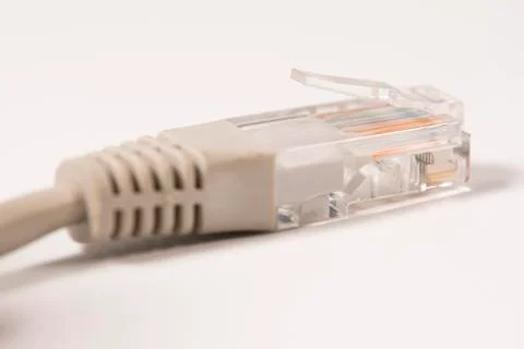 Gray Network Cable with molded RJ45 plug isolated against white background. Stock Photos