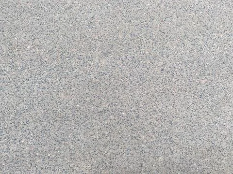 Gray new solid road asphalt with small stones. The background. Texture Stock Photos