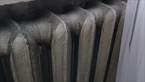 A gray old battery in the room. An old radiator in the house Stock Footage 313651937