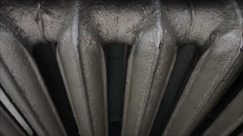 A gray old battery in the room. An old radiator in the house Stock Footage 313652128