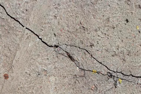 Gray old concrete surface with cracks on the surface Stock Photos