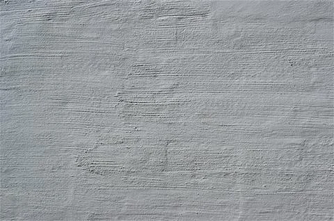 Gray old plaster on the wall. Decorative plaster structure background. Stock Photos