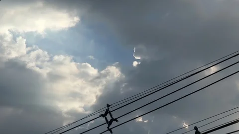 Gray overcast clouds on blue sky before rain or storm. Power lines in the sky. Stock Footage 96279259
