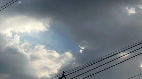 Gray overcast clouds on blue sky before rain or storm. Power lines in the sky. Stock Footage 96279448