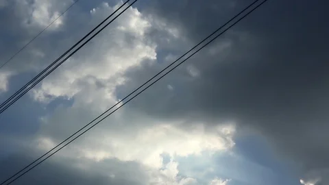Gray overcast clouds on blue sky before rain or storm. Power lines in the sky. Stock Footage 96279589